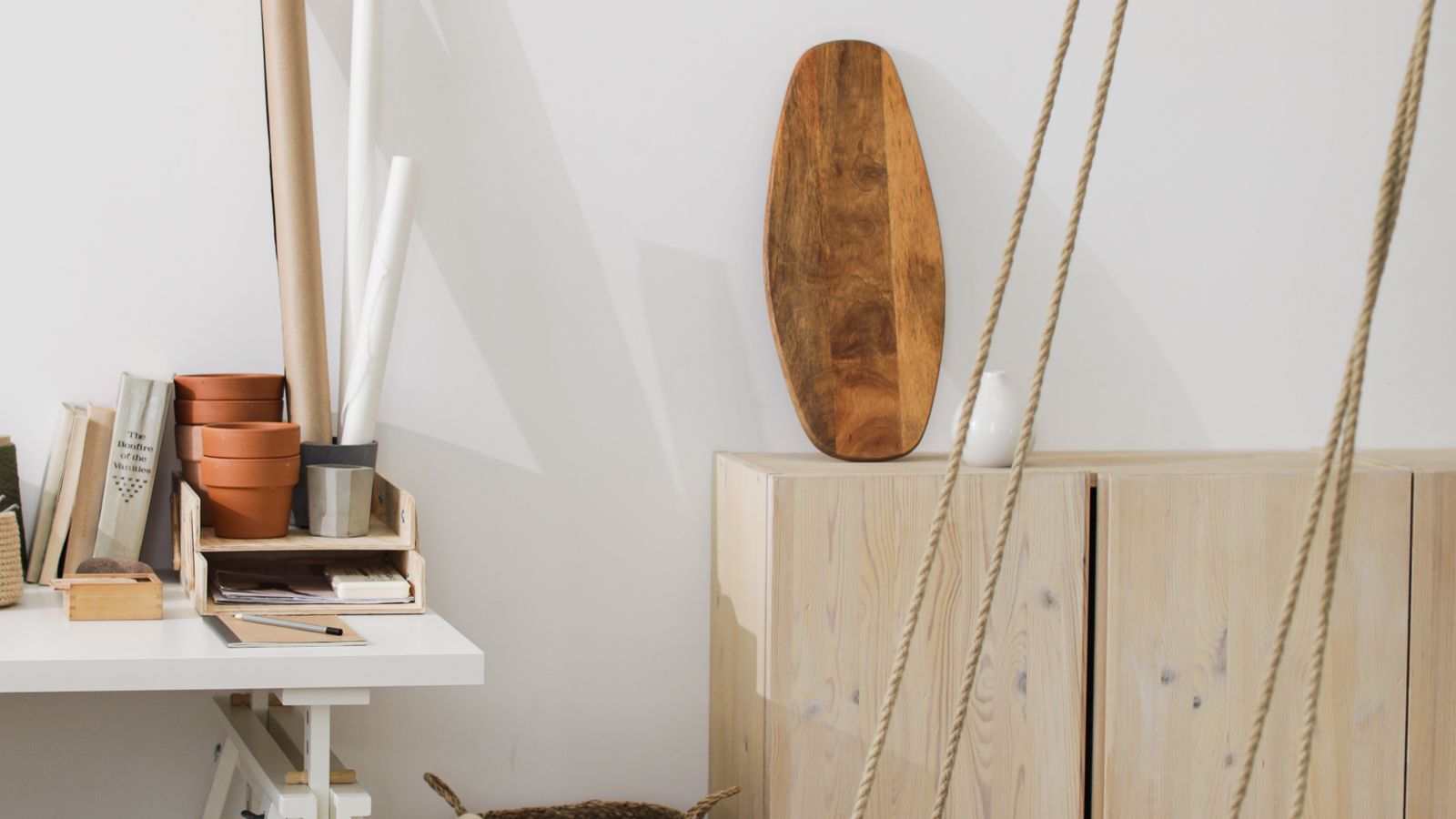 Folding wall mounted desk with laptop and monitor in a narrow home workspace